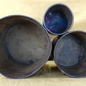 May include: Three wooden nesting boxes, the largest is brown and the two smaller boxes are a darker brown. The inside of the boxes are visible and show signs of wear.