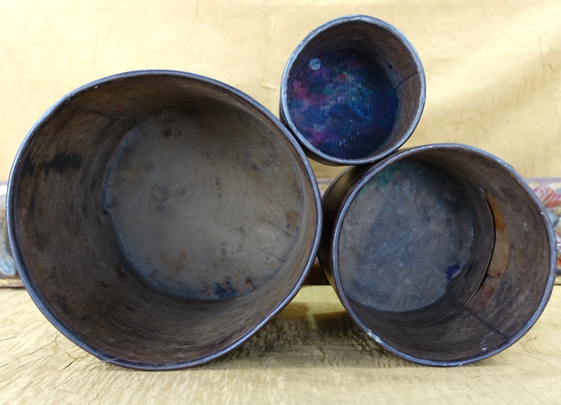 May include: Three wooden nesting boxes, the largest is brown and the two smaller boxes are a darker brown. The inside of the boxes are visible and show signs of wear.