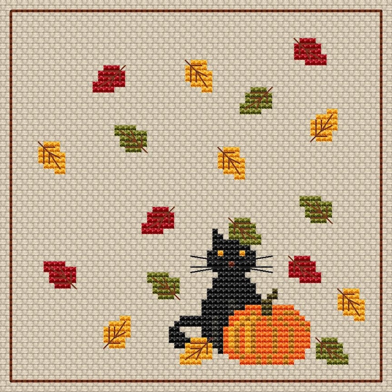 May include: Cross-stitch design showing a black cat beside an orange pumpkin, with falling autumn leaves in red, green, and yellow. The background is a light beige fabric with a brown border, creating a seasonal theme.