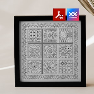 May include: Black and white geometric pattern cross stitch design in a black frame. The design features nine different geometric patterns.