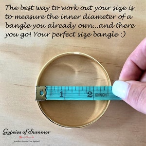 May include: A gold bangle bracelet being measured with a blue tape measure. The tape measure reads 2 60/inch. The text on the image reads "The best way to work out your size is to measure the inner diameter of a bangle you already own...and there you go! Your perfect size bangle :) Gypsies of Summer Jewellery for the Free Spirited"