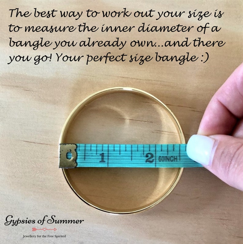 May include: A gold bangle bracelet being measured with a blue tape measure. The tape measure reads 2 60/inch. The text on the image reads "The best way to work out your size is to measure the inner diameter of a bangle you already own...and there you go! Your perfect size bangle :) Gypsies of Summer Jewellery for the Free Spirited"