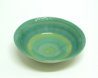 Pottery handmade, ceramic bowl with turquoise, green, and blue shining shades. Home gift.