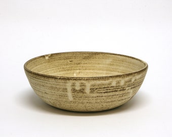 Ceramic bowl with beige and brown hues, resembling natural stone look. Home handmade gift.