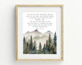 May include: A framed print with a watercolor illustration of a forest with mountains in the background. The print features the Bible verse John 3:16-17, which reads: "For God so loved the world, that he gave his only Son, that whoever believes in him should not perish but have eternal life. For God did not send his Son into the world to condemn the world, but in order that the world might be saved through him."