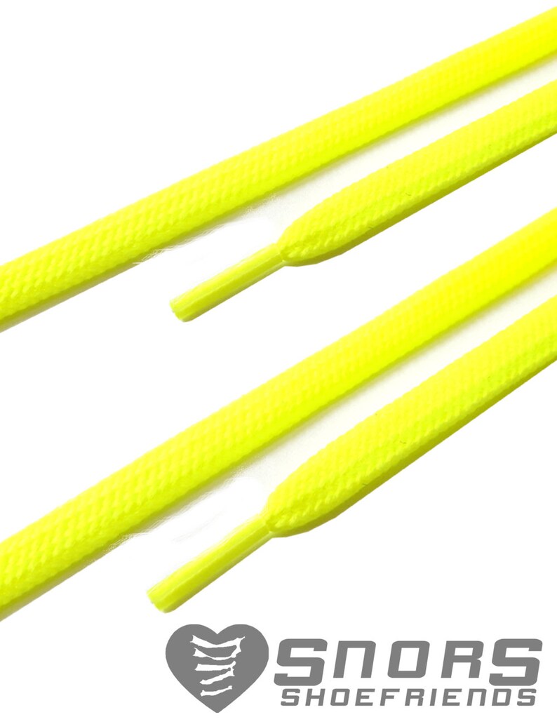May include: Bright yellow shoelaces with textured surfaces are displayed against a white background. The shoelaces are angled, showcasing their shape and design. The logo "SNORS SHOEFRIENDS" is visible at the bottom.
