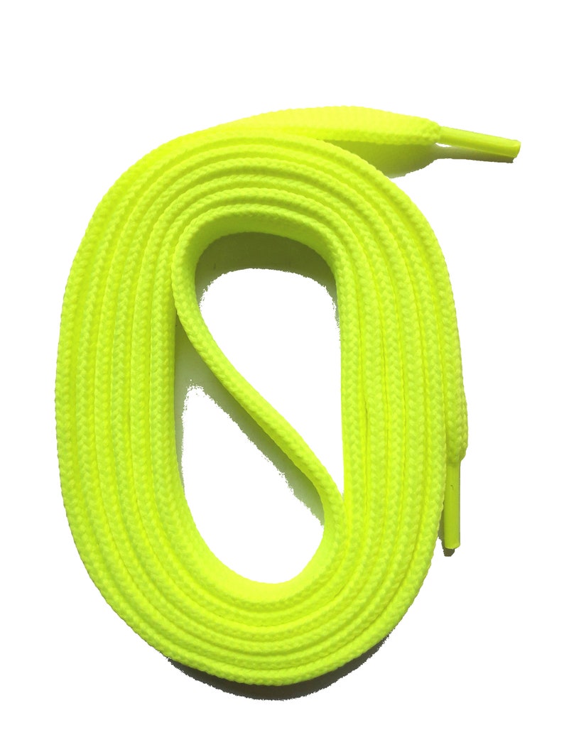 May include: Bright neon yellow shoelaces, coiled in an oval shape, against a white background. The laces have a woven texture and are designed for athletic shoes or sneakers. The aglets are a matching neon yellow.