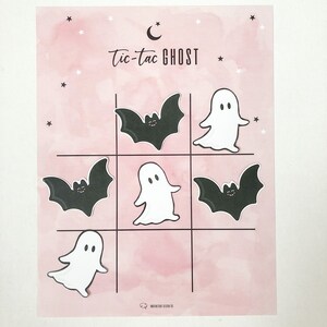 May include: A pink and white printable tic-tac-toe game with a crescent moon and stars. The game features ghosts and bats.