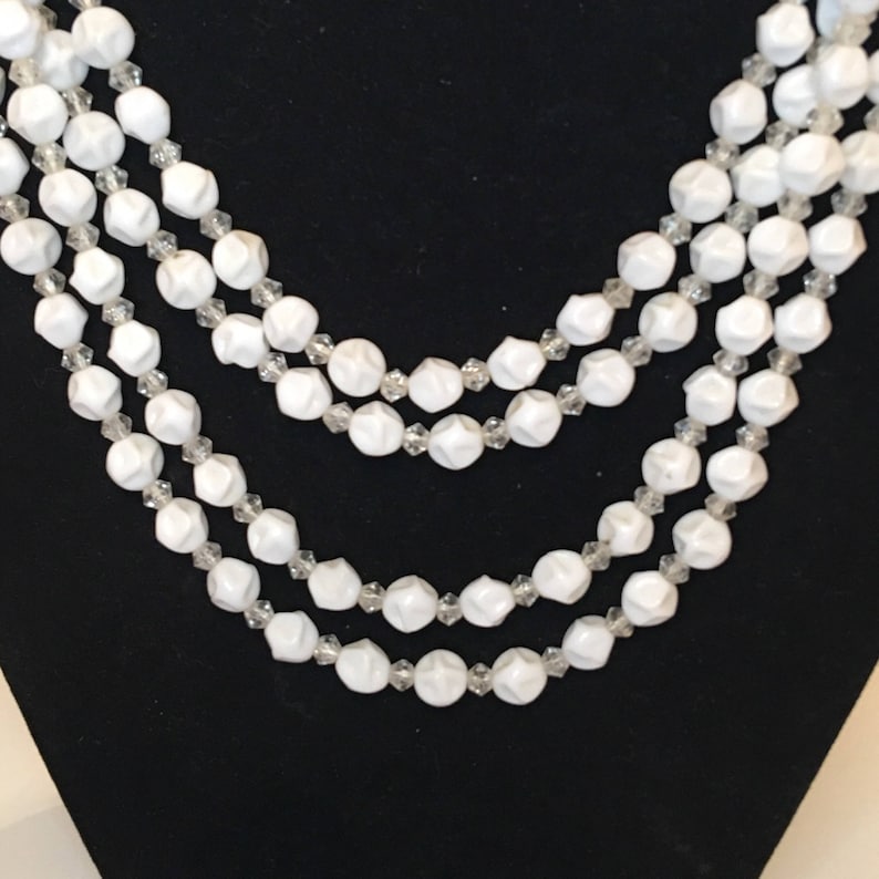 Classic Beauty Comes In This 4 Strand Beaded Necklace With Clasp.