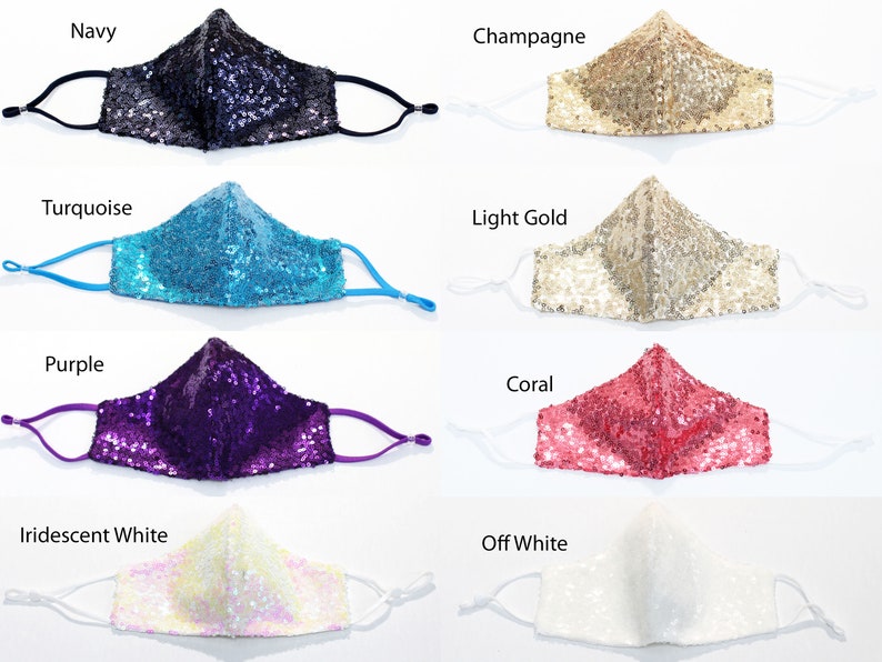 May include: Eight face masks made of sequins in various colors, including navy, champagne, turquoise, light gold, purple, coral, iridescent white, and off white.