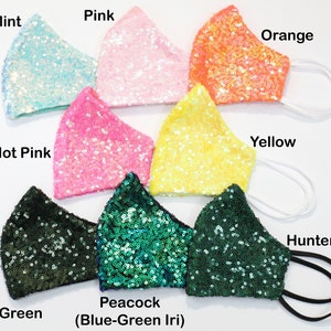 May include: Assortment of ten face masks made of sequined fabric in various colors, including aqua, pink, orange, yellow, hot pink, forest green, peacock, and hunter green.