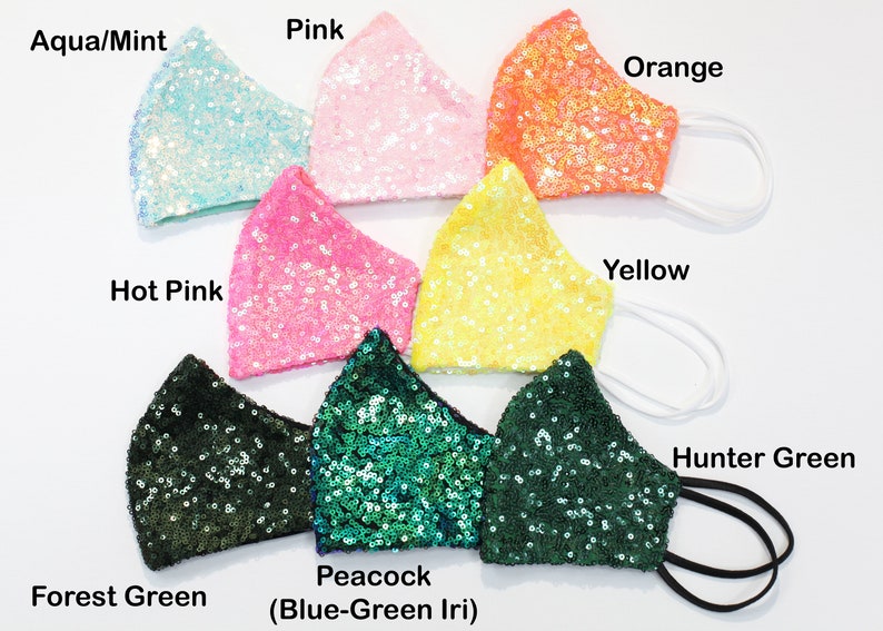 May include: Assortment of ten face masks made of sequined fabric in various colors, including aqua, pink, orange, yellow, hot pink, forest green, peacock, and hunter green.