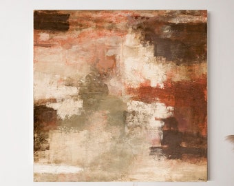 May include: Two wicker chairs with white cushions and a throw blanket, a small wooden table with books and a vase with dried flowers, and a large abstract painting with brown, beige, and white colors on a white wall.