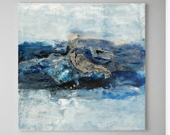 May include: Abstract painting with blue, white, and gray colors. The painting depicts a swirling, abstract landscape with a sense of movement and depth. It is framed and hanging on a white wall in a room with two chairs and a small table.