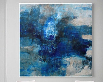 May include: Abstract painting in shades of blue and gray, with a textured finish. The painting is hanging on a white wall in a room with two chairs and a small table.