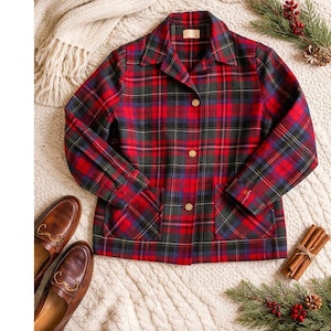 May include: A red, black, and blue plaid jacket with wooden buttons and two front pockets. The jacket is paired with brown leather loafers. The jacket is a classic style, perfect for fall or winter.