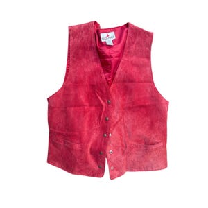 May include: A red suede vest with a V-neck and button closure. The vest has two front pockets and a satin lining. The brand name "Crazy Horse" is visible on the label.