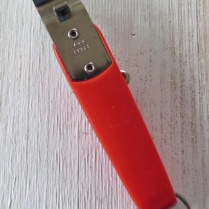 May include: A set of three ceramic mugs with a speckled, cream-colored glaze. Each mug features a different hand-painted floral design in shades of blue, green, and yellow. The mugs have a simple, rounded shape and a comfortable handle.