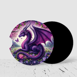 May include: A purple dragon rests in a field of flowers on a round car coaster. The dragon has large wings and is surrounded by pink and purple flowers and butterflies. A second black coaster is next to the dragon coaster.