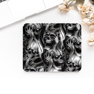 May include: A black and white graphic design featuring a repeating pattern of skulls with their hands covering their eyes. The skulls are depicted in a stylized, almost ghostly manner.