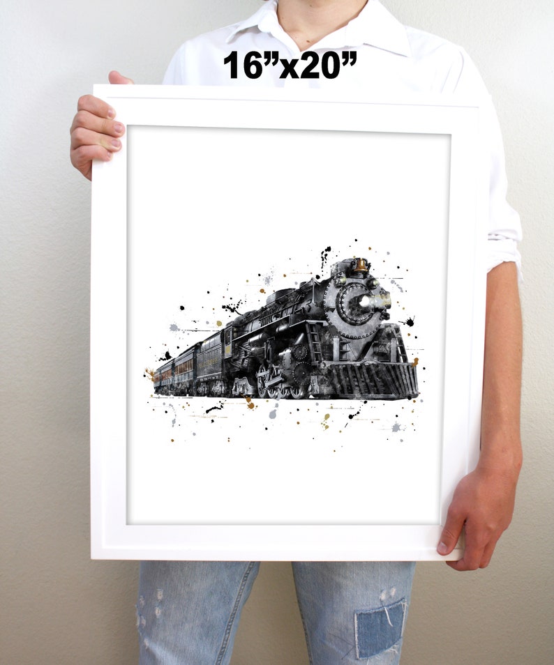 May include: A black and white watercolor print of a vintage steam locomotive with a splash of gold paint. The print is framed in a white frame and measures 16 inches by 20 inches.
