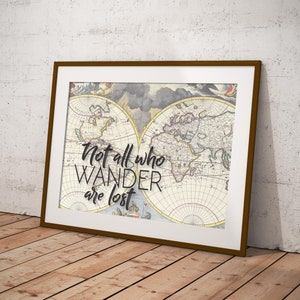 May include: A framed print with an antique world map and the quote "Not all who wander are lost". The map is in shades of brown, blue, and green. The quote is in black text.