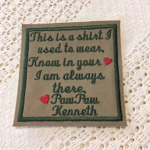 May include: A beige fabric patch with a green border and red hearts. The text on the patch reads: "This is a shirt I used to wear. Know in your I am always there. Rush Rush Kenneth."