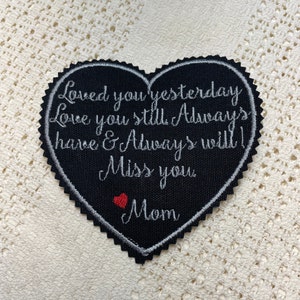May include: Black heart-shaped patch with white embroidered text that reads "Loved you yesterday Love you still Always have & Always will! Miss you Mom" with a small red heart below the word "Mom".