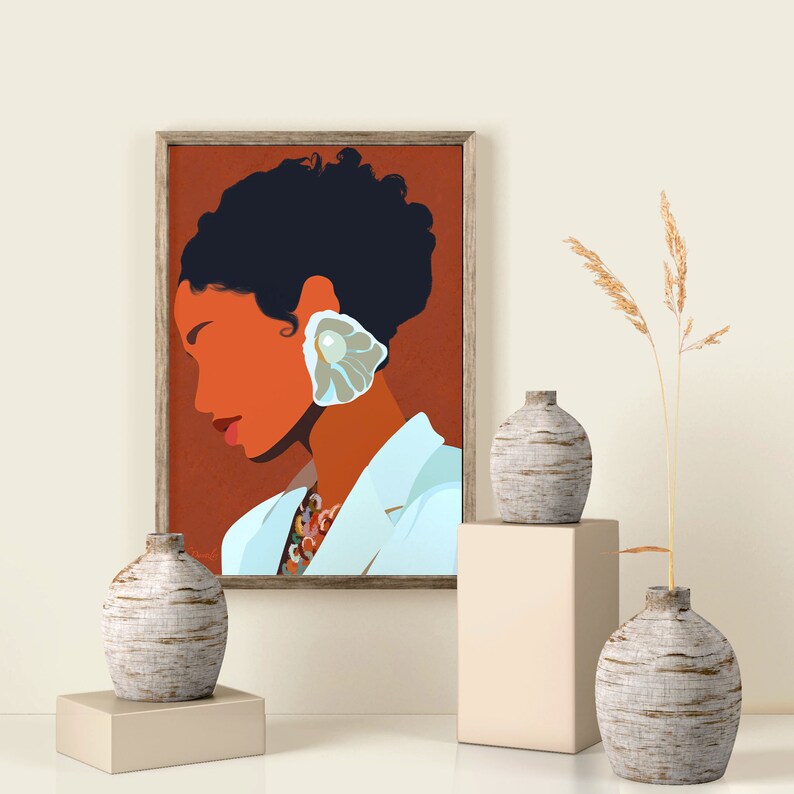 May include: An art print in a wooden frame depicts a woman with dark hair and an orange complexion, wearing a white jacket and a large, shell-shaped earring. The print is displayed with three textured, gray vases on pedestals, and a tall, dried plant.