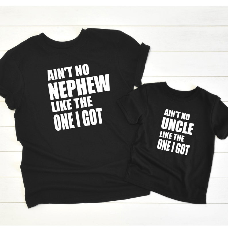 May include: Two black t-shirts with white text. The larger shirt says "Ain't no Nephew like the one I got". The smaller shirt says "Ain't no Uncle like the one I got".