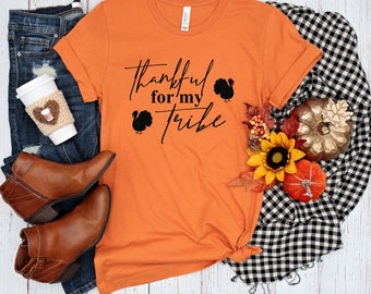 May include: Orange t-shirt with the text "thankful for my tribe" in black script with a turkey silhouette on each side of the text.