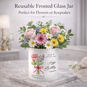 May include: A reusable frosted glass jar filled with a bouquet of pink roses, daisies, and yellow flowers. The jar has a floral design and the text "Happy Birthday Katherine". The jar is perfect for flowers or keepsakes.