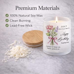 May include: A lit, frosted glass candle with a floral bouquet design and the text "Happy Birthday Katherine." The candle has a wooden lid and sits next to soy wax flakes. The text reads "100% Natural Soy Wax, Clean Burning, Lead-Free Wick."