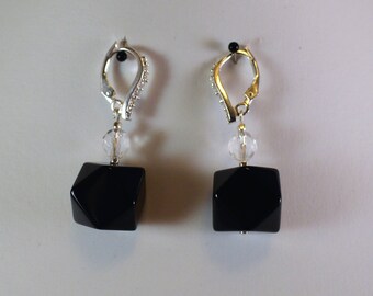 May include: A pair of black onyx earrings with clear crystal accents and silver leverback closures.