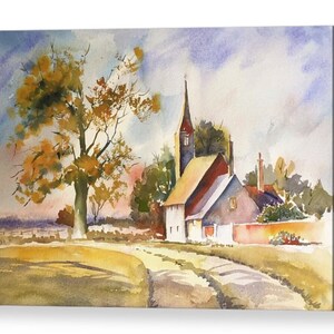 May include: Watercolor painting of a small village with a church, a tree, and a winding road. The sky is a soft blue with white clouds. The buildings are painted in shades of white, red, and brown.