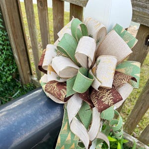 Christmas bow featuring deer and tree ribbon in brown, green and gold tones. Perfect for mailboxes, doors, wreaths and so much more.