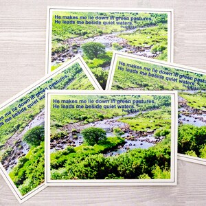 May include: Four cards with a green and blue nature scene of a stream and the text "He makes me lie down in green pastures, He leads me beside quiet waters. Psalm 23:2"