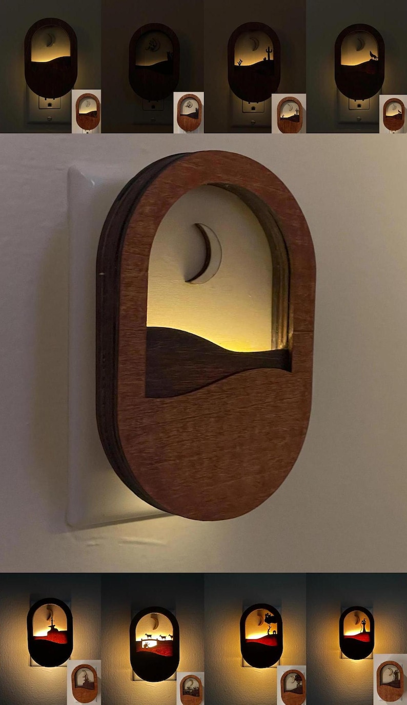 May include: A wooden night light with a crescent moon and a landscape design. The night light is plugged into an outlet and is lit up.