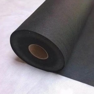May include: A roll of black landscape fabric, a weed barrier material used for gardening.