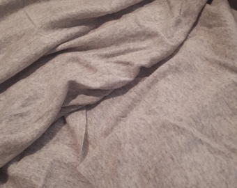 May include: A close-up of a gray, textured fabric with a soft, wrinkled appearance.