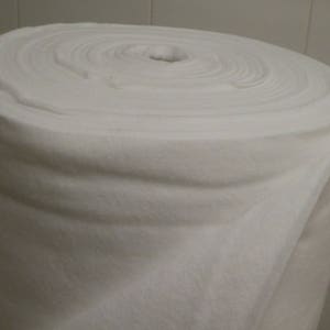 May include: A white roll of batting, a soft, fluffy material used for quilting and crafts.