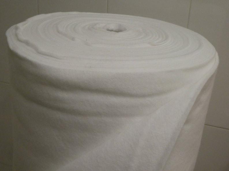 May include: A white roll of batting, a soft, fluffy material used for quilting and crafts.