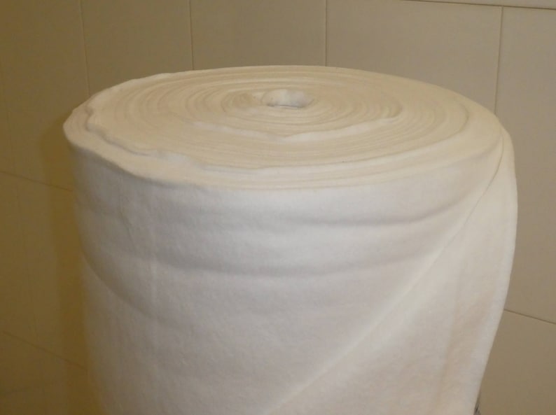 May include: A white, rolled up piece of batting, a soft, fluffy material used for quilting and crafts.