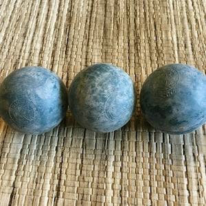 May include: Three blue rubber balls with a white star and the text "BURR'S" and "1965" printed on them.