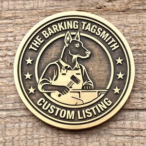 May include: A circular, bronze-toned metal tag with the text "THE BARKING TAGSMITH CUSTOM LISTING" around the edge. The centre features a dog blacksmith with a hammer and anvil, surrounded by stars. The tag has a vintage, handcrafted appearance.