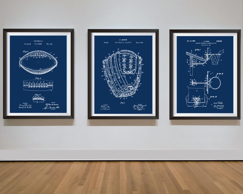 May include: Three framed vintage patent drawings on a white wall. The drawings are on a blue background and show a football, a baseball glove, and a basketball hoop. The text on the drawings includes the patent numbers and dates.