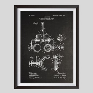 May include: Black and white vintage patent drawing of an optometrist's trial frame. The drawing shows the frame with lenses, a dial, and various other parts. The patent number is 748,732 and the date is January 5, 1904.