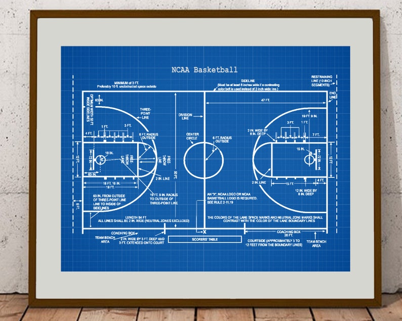 May include: A blueprint diagram of an NCAA regulation basketball court with all the lines and dimensions labeled. The court is blue with white lines and text.