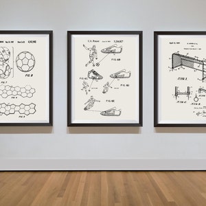 May include: Three black framed prints of vintage patent drawings for a football, football boots, and a football goal. The drawings are in black and white and include text and diagrams.