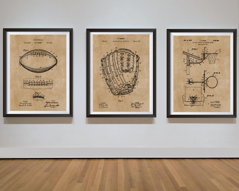 May include: Three framed vintage patent drawings of a football, baseball glove, and basketball hoop. The drawings are in black and white on a beige background. The frames are black.
